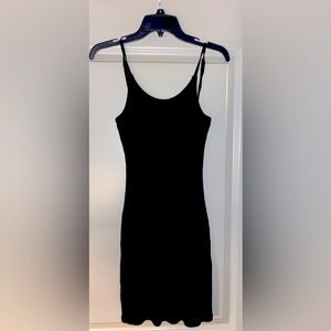 Black, ribbed, knee length body con dress with adjustable straps.